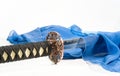 Japanese sword and a blue silk scarf Royalty Free Stock Photo