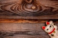 Japanese symbol of good luck Maneki Neko cat on old wooden background.