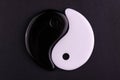 Japanese symbol of masculine and feminine beginning yin yang on a black background.