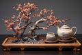 japanese teapot and tea cups set on a tray, with a bonsai tree beside Royalty Free Stock Photo