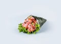 Japanese Temaki Hand Roll Sushi with Maguro tuna, flying fish roe Tobiko caviar, avocado, salad leaf, rice, black and white sesa Royalty Free Stock Photo