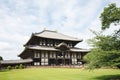 Japanese temple at Nara city with japanese maple tree leaves in Kyoto vintage film style Royalty Free Stock Photo