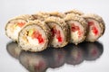 Japanese tempura hot sushi roll on white background with reflection. Sushi pieces with salmon, eel, cucumber, cream