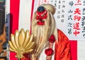 Japanese Tengu dressed in Suzukake kimono holding a golden fan during the Shimokitazawa parade festival.