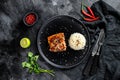 Japanese Teriyaki grilled salmon fillet glazed in delicious sauce with a side dish of rice. Black background. Top view