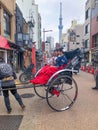 japanese tourists like to dress as Geishas and going on a sightseeing tour by rickshaw in Tokyo