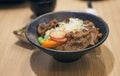 Japanese traditional dish Gyudon made from thinly sliced beef.soy sauce and rice.vintage tone color process.selective focus.