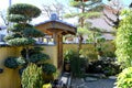 Japanese traditional garden gate in old Japanese house, Japanese stones garden with Japanese lantern, pine tree in front and bambo Royalty Free Stock Photo