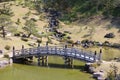 Japanese traditional garden with wooden bridge pond Royalty Free Stock Photo