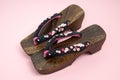 Japanese traditional geta sandal on pink background. Traditional Japanese asian wood footwear called Geta