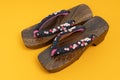 Japanese traditional geta sandal on yellow floor. Traditional Japanese asian wood footwear called Geta