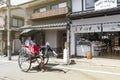 Japanese traditional hand pulled rickshaw carrying tourists on Matsubara street in Kyoto, Japan Royalty Free Stock Photo