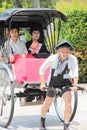 Japanese traditional hand pulled rickshaw carrying two ladies along Kyoto streets Japan