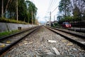 Japanese train tracks besides a freeway