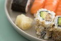 Japanese tuna avocado inside out California with salmon Nigiri and Maki on sushi mix plate Royalty Free Stock Photo