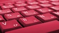 Japanese typing. Laptop keyboard closeup. Symbols on buttons of hiragana. Bright red tinted computer wallpaper or background.