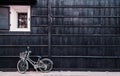 Japanese vintage white bicycle with black wooden wall of old house. Hida Furukawa, Gifu - Japan Royalty Free Stock Photo