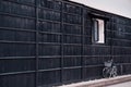 Japanese vintage white bicycle with black wooden wall of old house. Hida Furukawa, Gifu - Japan