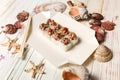 Japanese Volcano Sushi Roll on delivery box with chopsticks. Asian dish with raw salmon, flying fish roe Tobiko served with Unag