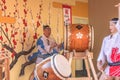 Japanese Wadaiko or Taiko drums played by boys and girls in short happi kimono with hachimaki on Royalty Free Stock Photo