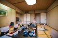 A Japanese waitress in kimono preparing the Kaiseki cuisine