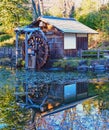 Japanese water wheel house reflecting in pond