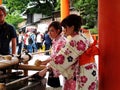 Japanese wear traditional clothing kimono and yukata washing hand rite or mitarashi ritual with chozusha or holy water in wash