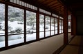 Japanese winter garden viewed from inside traditional room with panorama windows