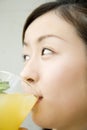 Japanese woman drinking orange juice Royalty Free Stock Photo