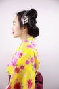 Traditional Asian Japanese beautiful Geisha woman wears kimono smile and hold a fan on hand on a white background Royalty Free Stock Photo