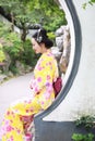 Traditional Asian Japanese woman Geisha wearing kimono play in a graden Royalty Free Stock Photo