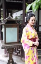 Traditional Asian Japanese woman Geisha wearing kimono play in a graden Royalty Free Stock Photo