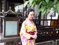 Traditional Asian Japanese woman Geisha wearing kimono play in a graden