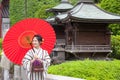 Japanese woman in kimono with red umbrella