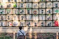 a Japanese woman looks at the Sake barrel installation at the Meiji Shrine