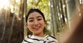 Japanese woman, portrait and selfie in forest with smile, pride and bamboo in bush for post on web blog. Girl, person