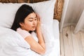 Japanese Woman Sleeping Lying In Comfortable Bed Resting In Bedroom Royalty Free Stock Photo