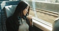 Japanese woman, sleeping and train with travel, headphones and public transportation on metro bullet. Young person Royalty Free Stock Photo