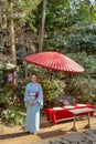 Japanese Woman in Traditional Blue Kimono with Tachidoro and Umbrella