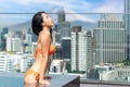 Japanese woman travel and relax in hotel rooftop swimming pool