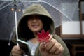 Japanese woman wearing hood sweater toothy smiling face and red