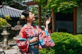 Japanese woman wearing kimono looking up the tree Royalty Free Stock Photo