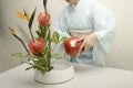 Japanese woman who does flower arrangement Ikebana Royalty Free Stock Photo