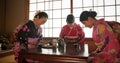 Japanese, women and bow for tea ceremony in Chashitsu room with kimono dress or custom tradition. People, temae and Royalty Free Stock Photo