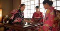 Japanese, women and kimono for tea ceremony in Chashitsu with matcha or custom tradition. People, temae and vintage Royalty Free Stock Photo