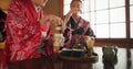 Japanese, women and kimono for tea ceremony in Chashitsu room with peace or custom tradition. People, temae and vintage Royalty Free Stock Photo