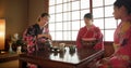 Japanese, women and matcha for tea ceremony in Chashitsu with kimono dress and traditional custom. People, temae and