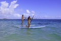 Japanese women on paddleboards Royalty Free Stock Photo