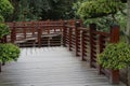 A Japanese wooden bridge in a garden over a lake Royalty Free Stock Photo