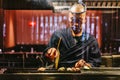 Japanese Yakitori Chef is grilling chicken marinated with ginger, garlic and soy sauce with a lot of smoke